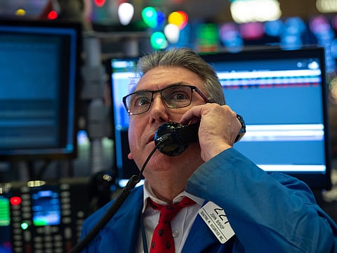 Traders work on the floor at the closing bell of the Dow Industrial Average at the New York Stock Exchange on December 19, 2018 in New York.