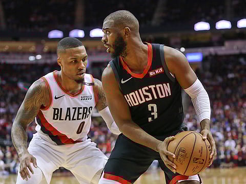 Houston Rockets guard Chris Paul (3) looks to pass the ball against Portland Trail Blazers guard Damian Lillard (0) in the second half at Toyota Center