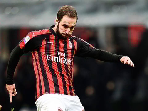 AC Milan's Argentine forward Gonzalo Higuain vies for the ball during the Italian Serie A football match between AC Milan and Torino at the San Siro stadium in Milan, on December 9, 2018.