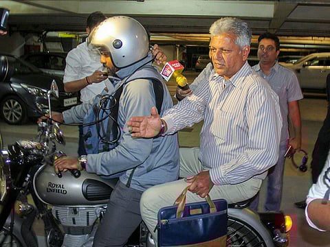 Former cricketer WV Raman (riding pillion) outside BCCI headquarters in Mumbai, Thursday, December 20, 2018.