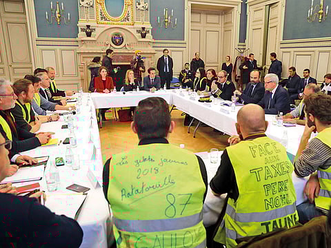French Prime Minister Edouard Philippe speaks with “yellow vest” representatives at Limoges’ city hall in central western France, to discuss reforms following the tax cuts.