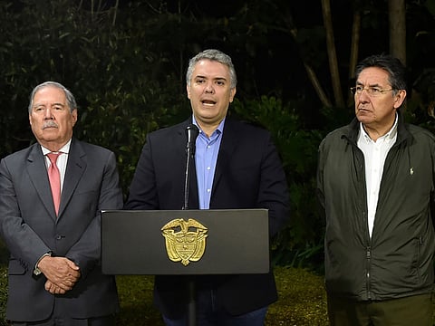 Colombian President Ivan Duque (C) speaks next to Colombian Defense Minister Guillermo Botero (L) and Colombian Attorney General Nestor Humberto Martinez (R) at the Narino presidential palace in Bogota on December 21, 2019. FARC dissident Walter Patricio Arizala, aka "Guacho", wanted in Colombia and Ecuador, was killed Friday in an operation of the Colombian forces near the border with Ecuador, authorities said