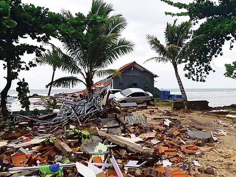 A car lies among ruins after a tsunami hit Carita beach  in Pandeglang, Banten province, Indonesia.