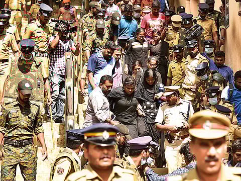 Policemen escort women activist from NGO ‘Manithi’ as they return back after being surrounded by Hindu activist to stop their attempt to reach Sabarimala Ayyappa temple in Pamba in the southern state of Kerala.