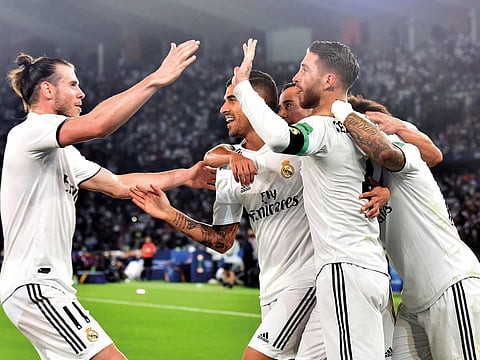 Real Madrid players celebrate after their win over Al Ain in the final of the Fifa Club World Cup at the Zayed Sports City in Abu Dhabi on Saturday night. Real won 4-1 to complete a hat-trick of titles.