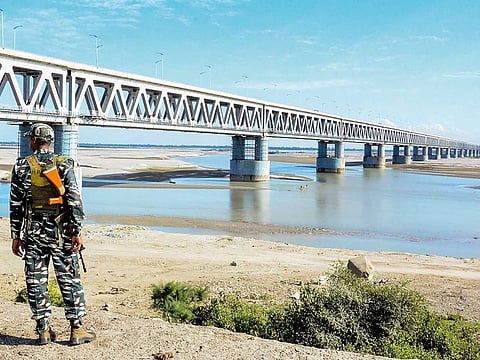 A security personnel stands beside Bogibell Bridge in Dibrugarh. 