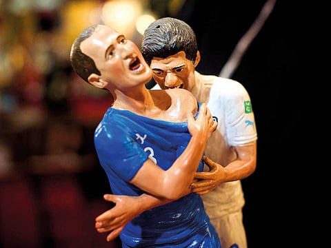 Genny Di Virgilio works on a figurine in his workshop. 