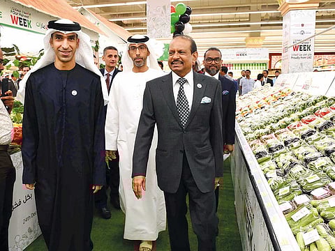 Dr Thani Bin Ahmad Al Zeyoudi and Yousuf Ali M.A. after they inaugurated the Harvest Week at Khalidiya Mall in Abu Dhabi on Monday. They also signed a ‘pledge for sustainability’.