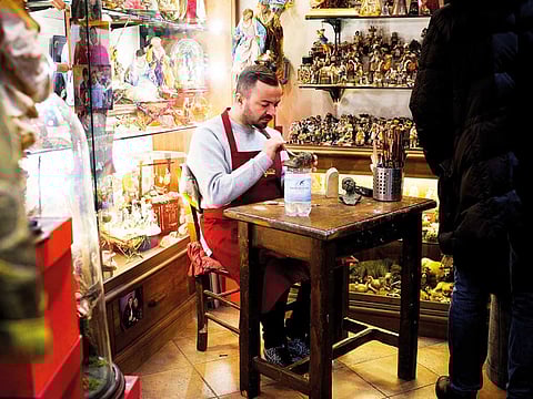 Genny Di Virgilio works on a figurine in his workshop. 