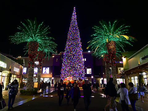  People shop for gifts before Christmas at an outlet mall in Commerce, California. 