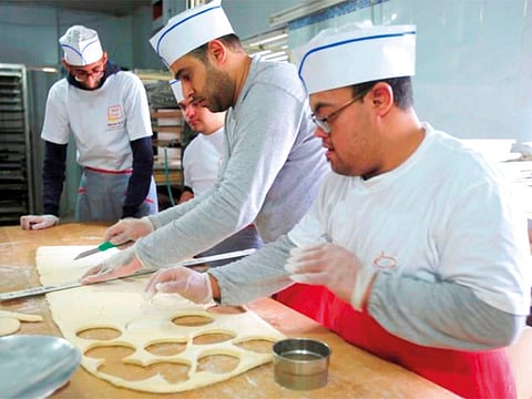 Ali Kerdi, 35, trains special needs students at a bakery in the southern city of Tyre, Lebanon December 18.