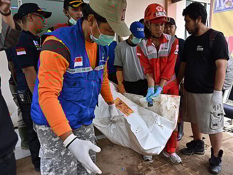 Indonesian emergency personnel carry the body of a victim at Berkah hospital in Pandeglang, Banten province.