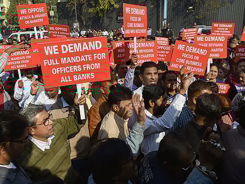 Bank employees stage a protest against the proposed merger of Vijaya Bank and Dena Bank with Bank of Baroda, as part of their nation-wide strike, in Ahmedabad.