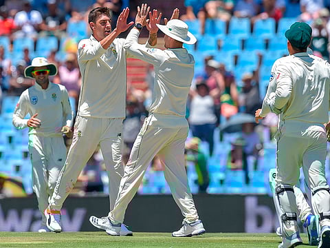 South Africa's Duanne Olivier celebrates after getting Pakistan's Sarfraz Ahmed's wicket during day one of the 1st cricket test match between them at SuperSport Park cricket stadium on December 26, 2018 in Pretoria.  