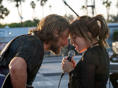 Bradley Cooper, left, and Lady Gaga in a scene from the latest reboot of the film, "A Star is Born."