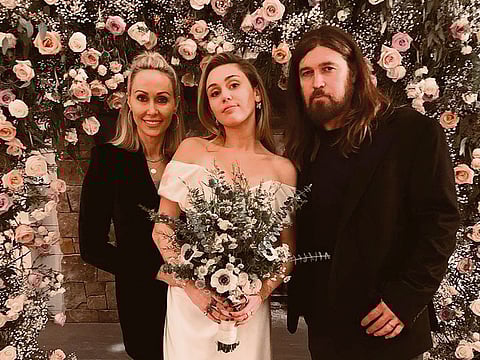 The Cyrus family: Tish, Miley and Billy Ray at the wedding.