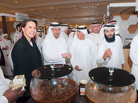 Mariam Al Muhairi and Dawood Al Hajiri at the third Hatta Honey Festival on Thursday.  The UAE Food Bank and Dubai Central Laboratory are participating for the first time.