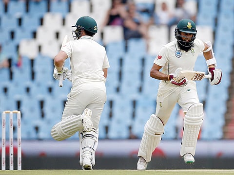 South Africa’s Hashim Amla and Dean Elgar take a run against Pakistan during the first Test at the SuperSport Park Stadium in Centurion.
