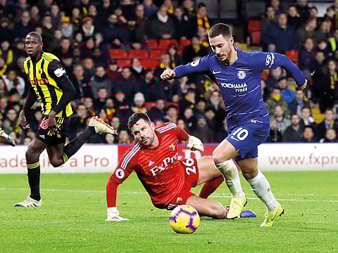 Chelsea’s Eden Hazard gets past Watford’s Ben Foster to score their first goal during a Premier League match in the Vicarage Road, Watford on Wednesday.