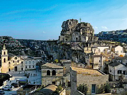 Visitors walking towards the cave church Madonna de Idris in Matera.