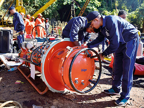 Navy personnel prepare diving equipment before entering a coal mine that collapsed in Ksan, Meghalaya.