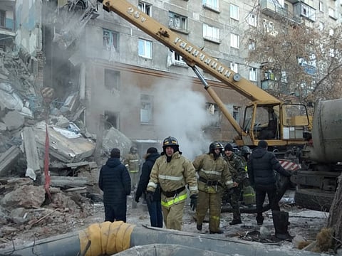 Emergency personnel work at the site of collapsed apartment building after a suspected gas blast in Magnitogorsk, Russia 