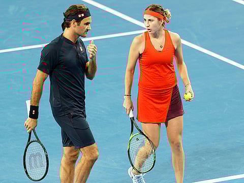 Roger Federer and Belinda Bencic of Switzerland talk during their mixed doubles match against Cameron Norrie and Katie Boulter of Britain at the Hopman Cup in Perth, Australia, Sunday December 30, 2018. 