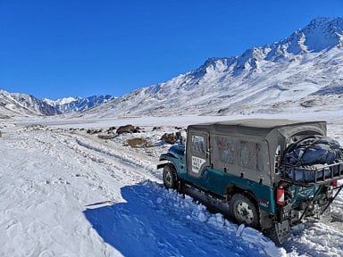 A 4x4 takes tourists to Shandur Pass. Cooperation is key to increasing awareness of sustainable tourism, activists say.