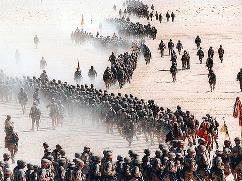 Responding to Iraq's invasion of Kuwait, troops of the US 1st Cavalry Division deploy across the Saudi desert November 4, 1990, during preparations prior to the Gulf War. 