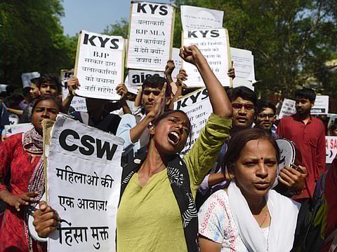In this file photo taken on April 12, 2018 Indian activists and students hold placards and shout slogans during a protest against rape of children in India 