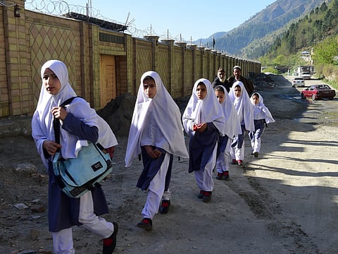 Pakistani students arrive at the Khpal Kor Model School, which was built with Malala Yousafzai's Nobel prize money, in Malala's home district of Shangla in Pakistan's Swat region, on March 30, 2018. Pakistan is planning a phased reopening of its educational institutions from September 15.