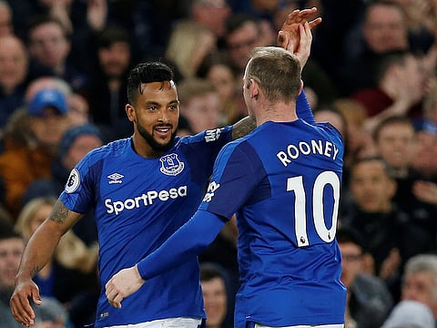 Everton's Theo Walcott celebrates scoring their first goal with Wayne Rooney.