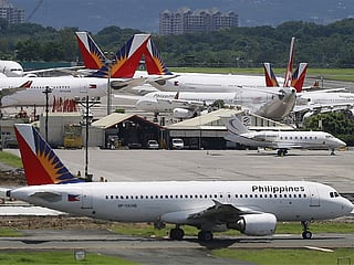 Philippine Airlines planes on the tarmac of Manila's Ninoy Aquino International Airport. 