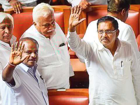 
Karnataka Chief Minister H D Kumaraswamy with his deputy G Parameshwara and other JD(S) and Congress leaders waves to the media after his coalition government won the trust vote by voice vote, at Vidhana Soudha in Bengaluru, on Friday.