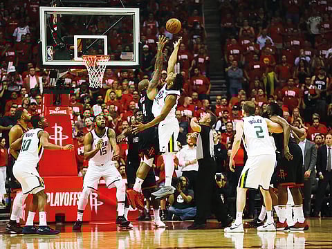 Donovan Mitchell of the Utah Jazz (white) goes up or a jump ball during one of their conference matches last year.