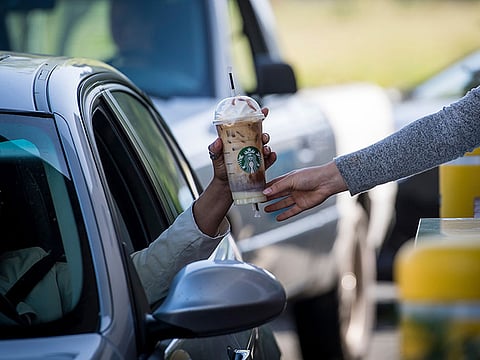 Go easy with the milk... Starbucks outlets will be topping up with non-dairy options as part of its carbon reduction programme. Pictured here is a drive-through counter in Rodeo, California. 