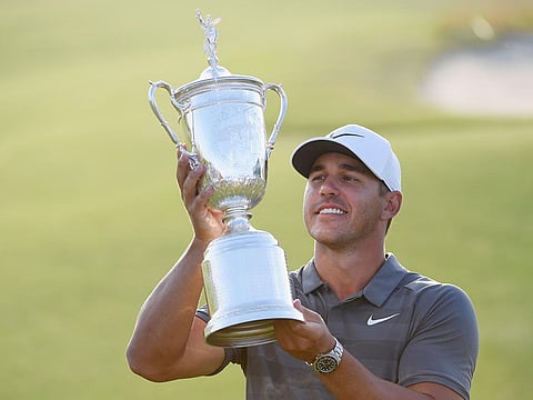 Brooks Koepka of the United States celebrates with the U.S. Open Championship trophy.