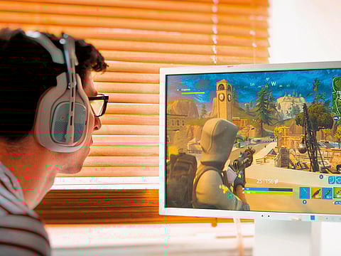 Teenager playing Fortnite video game 