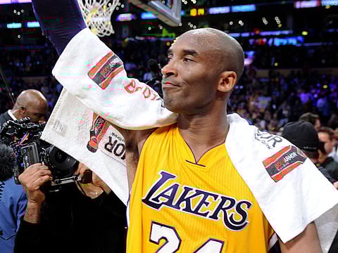 The Los Angeles Lakers' Kobe Bryant salutes the crowd after his final game, on April 13, 2016.