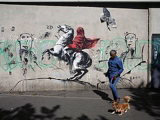 Street artist Banksy splashes Paris with works on refugees