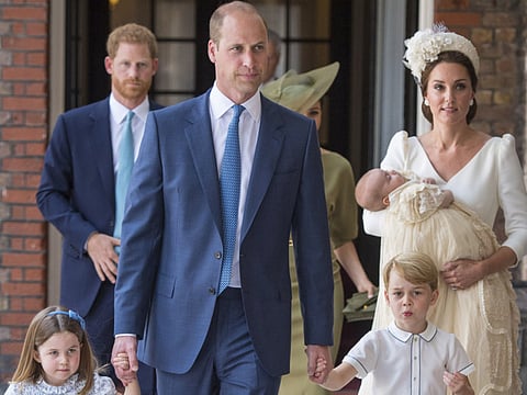 Princess Charlotte and Prince George hold the hands of their father Prince William while Kate, Duchess of Cambridge holds Prince Louis as they arrive for his christening service at the Chapel Royal, St James's Palace, London, Monday, July 9, 2018.