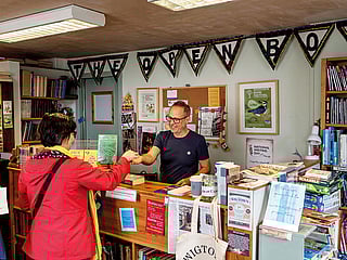 A critic sells books down by the seashore
