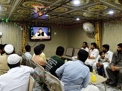 Pakistani men watch TV at a restaurant in Peshawar. Picture for illustrative purposes only.