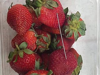 Explainer: Why are Australians putting needles in strawberries?