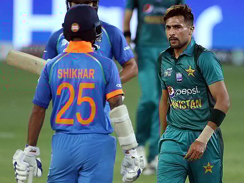 Pakistan's Mohammad Amir and India's Shikhar Dhawan during the Asia Cup ODI in Dubai in 2018. 
