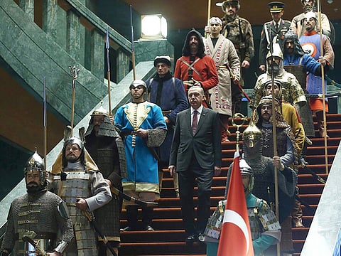 Turkey’s President Tayyip Erdogan walks down the stairs in between soldiers, wearing traditional army uniforms from the Ottoman Empire, as he arrives for a welcoming ceremony for Palestinian President Mahmoud Abbas (not pictured) at the Presidential Palace in Ankara January 12, 2015.
