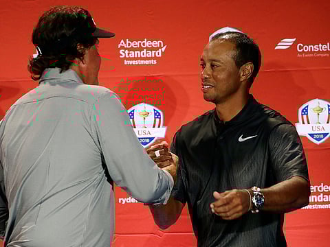 Tiger Woods (right) and defending champion Phil Mickelson were named among the entries for the PGA Championship, but organisers admitted there were still doubts about the latter's participation.