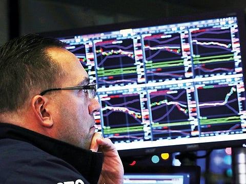 A trader looks at price monitors at the New York Stock Exchange. Technology stocks tumbled 18 per cent in their worst quarter since the fourth quarter of 2008.