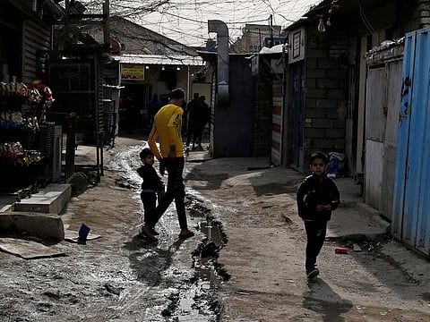 Palestinian refugees walk in a street in the Baladiyat neighbourhood of Baghdad, Iraq December 16, 2018. 