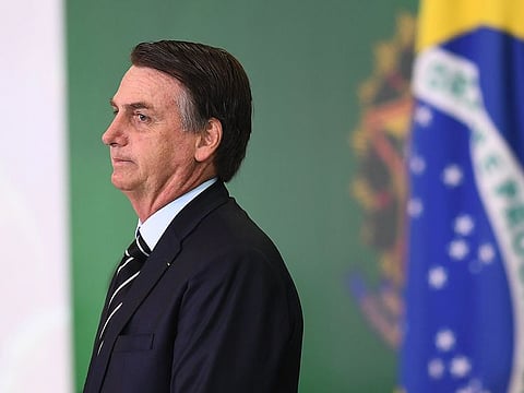 Brazilian President Jair Bolsonaro gestures during a ceremony in which some of the ministers of his cabinet take office a day after the swearing-in of the country's new government, at Planalto Palace in Brasilia, on January 2, 2019
